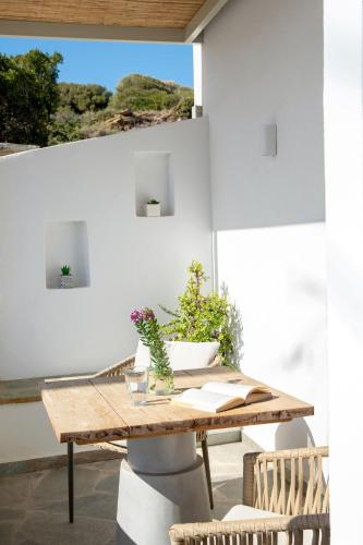 a wooden table with plants on a patio at Niriis Sea View Studio Melite Batsi in Batsi