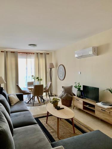 a living room with a couch and a table at Stylish Well-Equipped 2-bed flat in Nicosia Centre in Strovolos