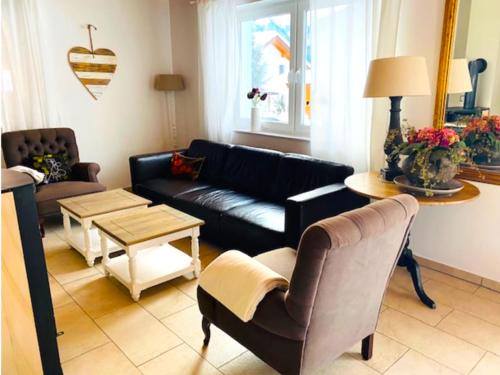 a living room with a couch and a table at Villa Sonnenpiste in Kötschach