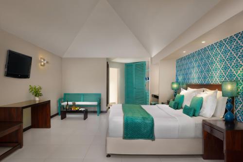 a hotel room with a bed and a tv at Beach Villa - The Maldives in North Male Atoll