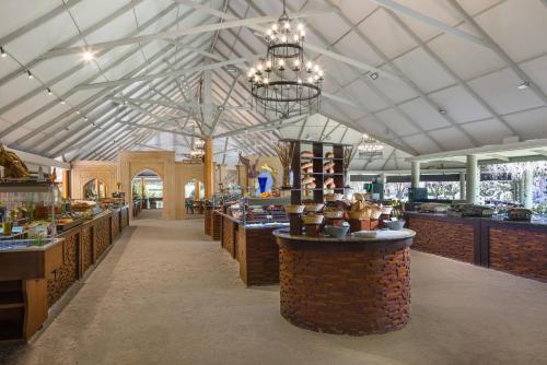 a restaurant with a large ceiling with chandeliers at Beach Villa - The Maldives in North Male Atoll