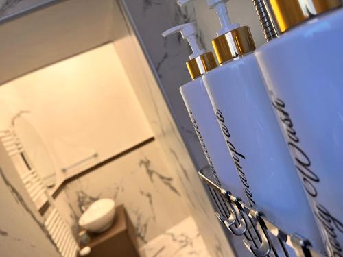 a bathroom with a mirror and a bottle of soap at La Casetta del Vicolo in La Spezia