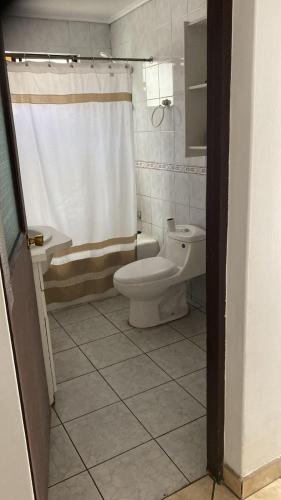 a bathroom with a toilet and a sink and a shower at Casona Campillay in La Serena
