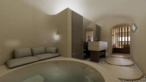 a bathroom with a large tub in a room at Agnadema Apartments in Firostefani