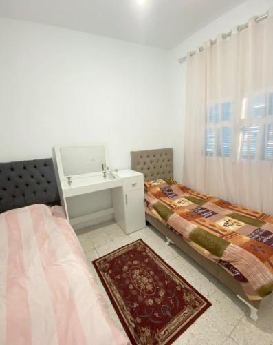 Ένα ή περισσότερα κρεβάτια σε δωμάτιο στο Appartement Ettahrir
