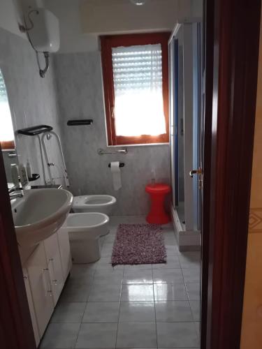 a bathroom with a sink and a toilet and a window at "La Casa sul fiume" in Marsico Nuovo