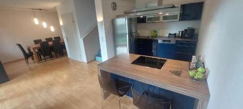 a kitchen with blue cabinets and a wooden counter top at Grazblick free Carport parking & self checkin in Graz