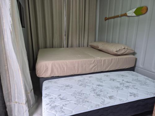 two beds sitting next to each other in a room at Aldeia Mar in Bertioga