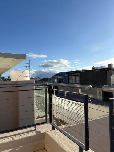 a balcony with a railing on top of a building at Blouberg Village Place in Cape Town