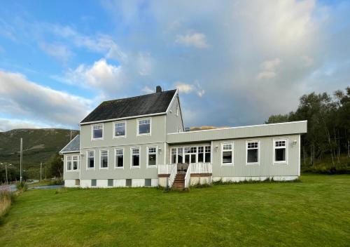 a white house with a lot of windows at Villa Godfjord in Sortland