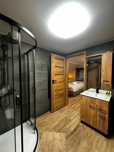 a bathroom with a shower and a sink and a tub at Góry Sowie przystanek DAD HOUSE in Sokolec