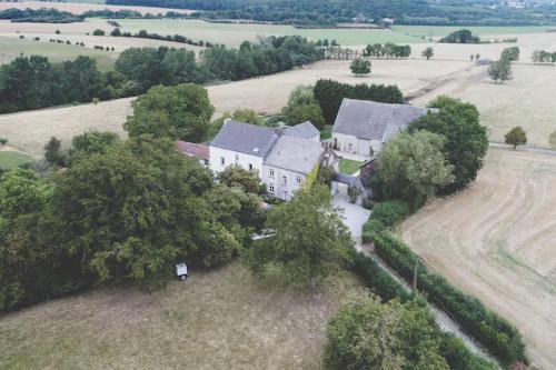 an aerial view of a large house in a field at Gîte Ferme de la Chevêche & Jacuzzi Namur in Sart-Saint-Laurent