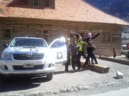 a group of people standing in front of a truck at Portezuelo del Viento - Hostel de Montaña in Las Cuevas