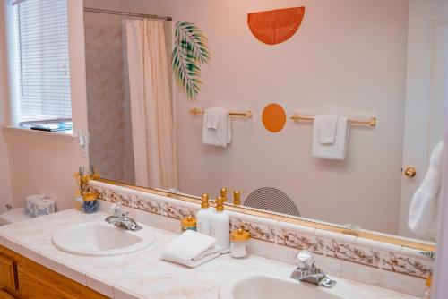 a bathroom with a sink and a mirror at Heaven Heights - HotTub, Pet Friendly, EV Outlet, Pool Table, Game Room, BBQ, FirePit, Library in Oakhurst