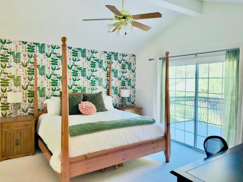 a bedroom with a bed and a ceiling fan at Heaven Heights - HotTub, Pet Friendly, EV Outlet, Pool Table, Game Room, BBQ, FirePit, Library in Oakhurst