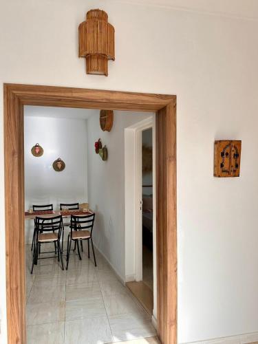 a dining room with a table and chairs at Dar Taoufik in Djerba