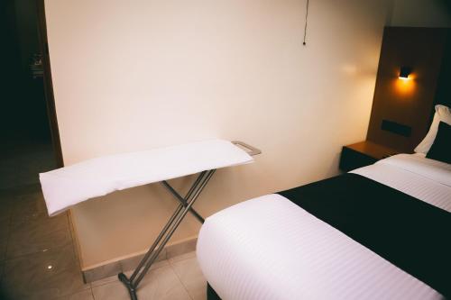 a hotel room with a bed and a desk at One Click Apartment in Kigali