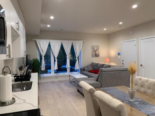 a living room with a couch and a table at Private 2BR Apartment - Free Off Street Parking, Fast Wi-Fi & Laundry in Washington, D.C.