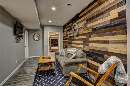 a living room with a wooden accent wall at Eagles Haven in Eagle River
