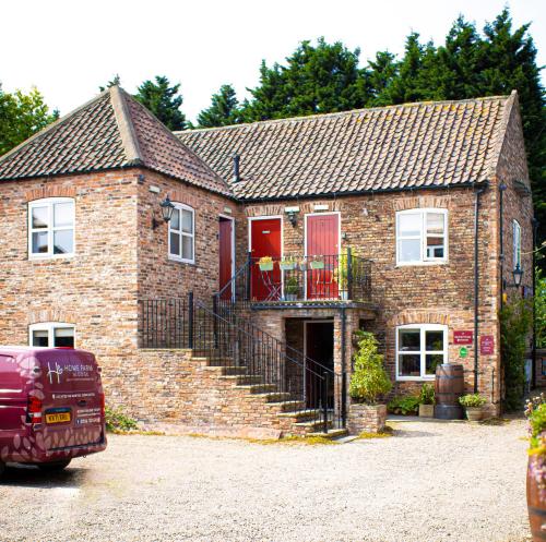 a brick house with a car parked in front of it at Home Farm & Lodge in Bawtry