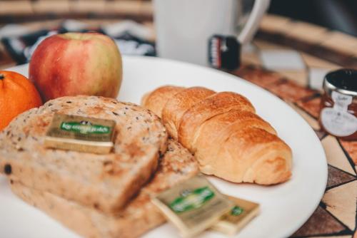 a plate of food with bread and apples on a table at Home Farm & Lodge in Bawtry