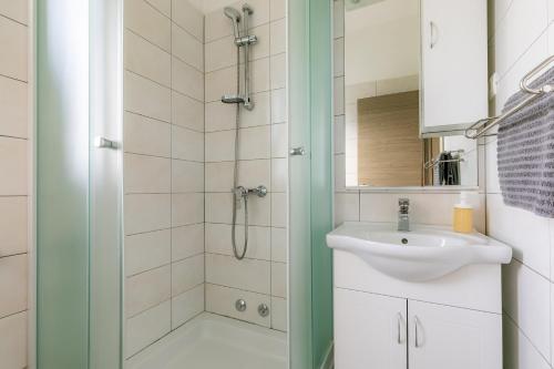 a bathroom with a sink and a shower at Holiday house Martinović in Prigradica