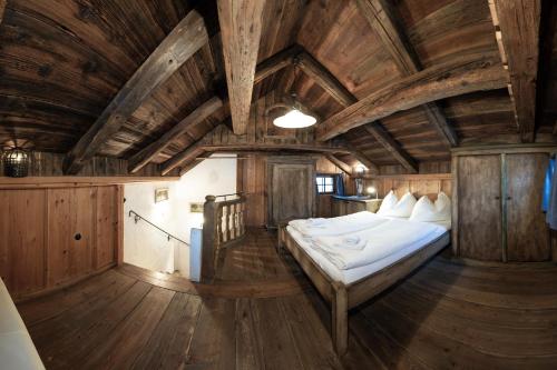 a bedroom with a bed in a room with wooden ceilings at Bretei Hütte in Grossarl