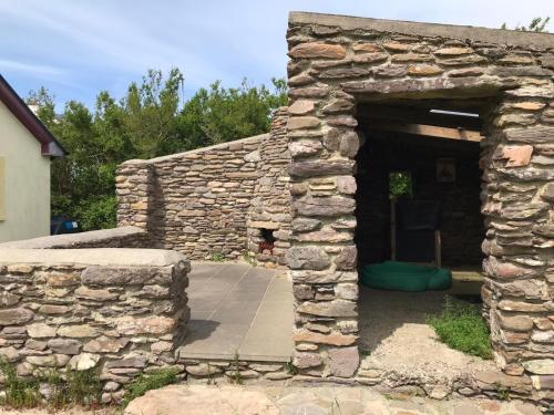 an entrance to a stone building with a doorway at Sunny Beaches in Ballinskelligs