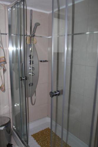 a shower with a glass door in a bathroom at Modern spotless house with full privacy and WiFi in Aglantzia Nicosia in Aglantzia