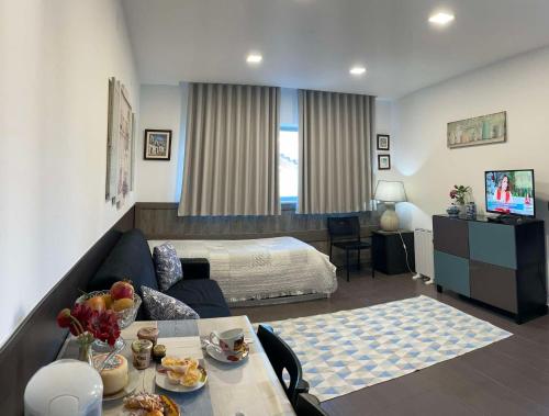 a hotel room with a bed and a living room at Casa da Avó Olinda in Góis