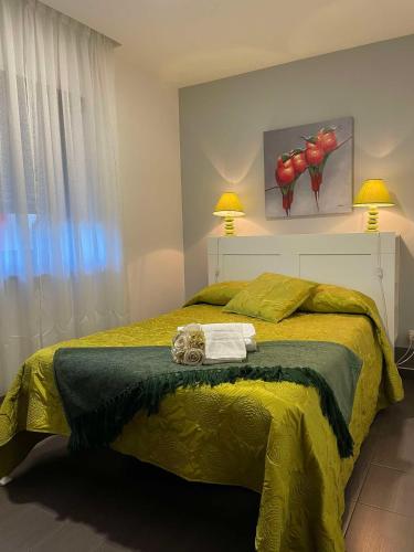 a bedroom with a bed with a yellow bedspread at Casa da Avó Olinda in Góis