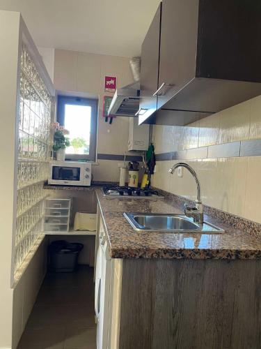 a kitchen with a sink and a counter top at Casa da Avó Olinda in Góis