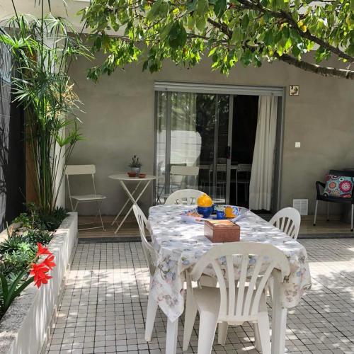 a white table and chairs on a patio at Casa da Avó Olinda in Góis