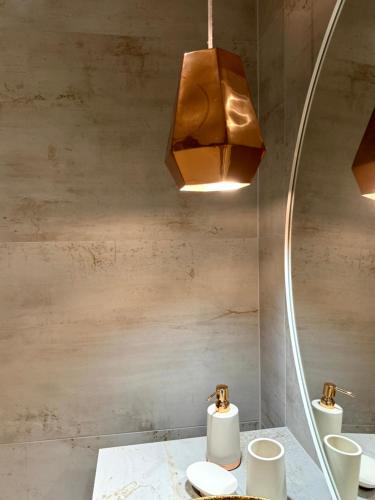a bathroom with two sinks and a mirror at Le Clos Vercheron in Artaix