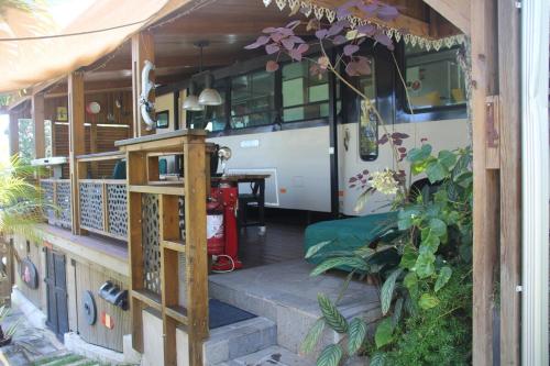 a front porch of a bus with stairs and plants at le mangue car hôte in Saint-Paul