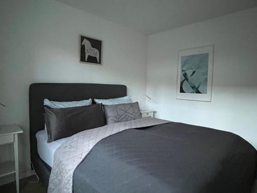 a bedroom with a bed and two pictures on the wall at Hotel Markgraf in Bad Bellingen