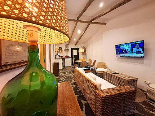 a large green bottle sitting on a table in a living room at Descanso dos oleiros in Aldeia do Mato