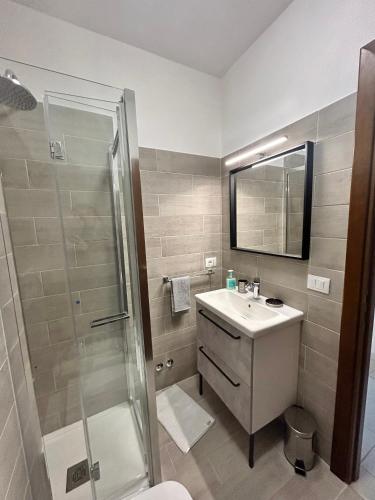 a bathroom with a sink and a shower at Appartamento Astri EUR in Rome