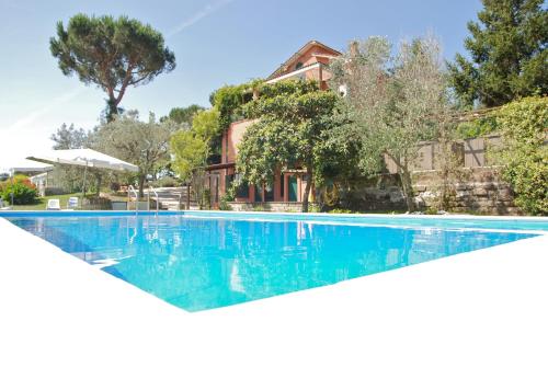 a swimming pool in front of a house at Vigna Licia in Pomezia