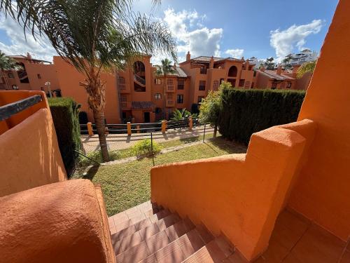 a view of a courtyard with buildings and trees at Piso de lujo Golf y Playa in Estepona