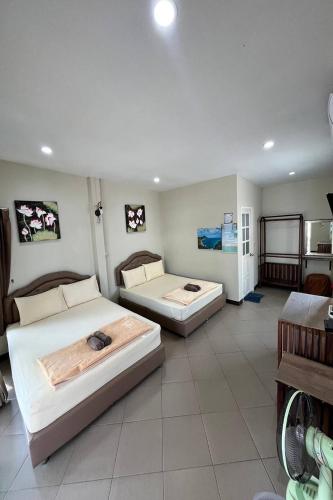 a bedroom with two beds in a room at Pleai Ta Lea Resort in Chao Lao Beach
