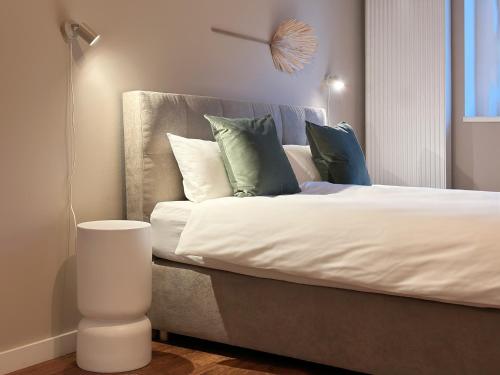 a bedroom with a bed with pillows on it at Design Apartment - Self-Check-In - Maschsee in Hannover