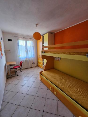 a room with two bunk beds and a desk at Villa Marta in Città della Pieve