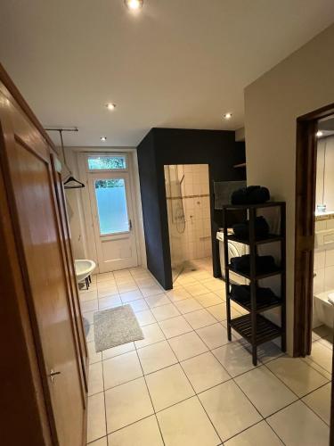 a bathroom with a sink and a toilet and a room at Chalet Mignon - your vacation oasis at Lake Brienz in Bönigen
