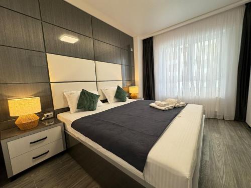 a bedroom with a large bed and a window at Bucharest Premium Luxury Studios & Apartments by Glam Story in Bucharest