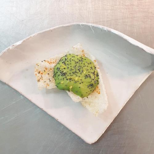 a piece of bread with a green topping on a plate at Il Castagneto Hotel in Melfi