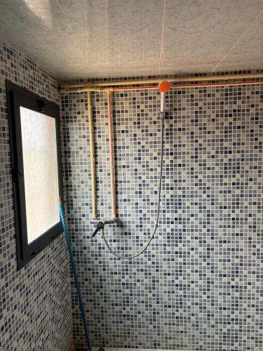a shower in the corner of a bathroom at Taddart Aglou in Zaouit Aglou