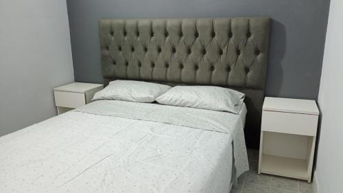 a bedroom with a large bed and two night stands at Dpto en San Antonio Oeste 2 pax in San Antonio Oeste