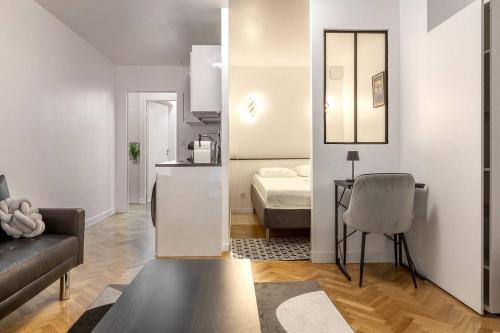 - un salon avec un canapé et une chambre dans l'établissement Stylish Escape in the Vibrant 11th arrondissement, à Paris