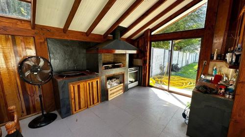 a kitchen with a stove top oven in a house at heated pool, barbecue area and full house in Licán Ray